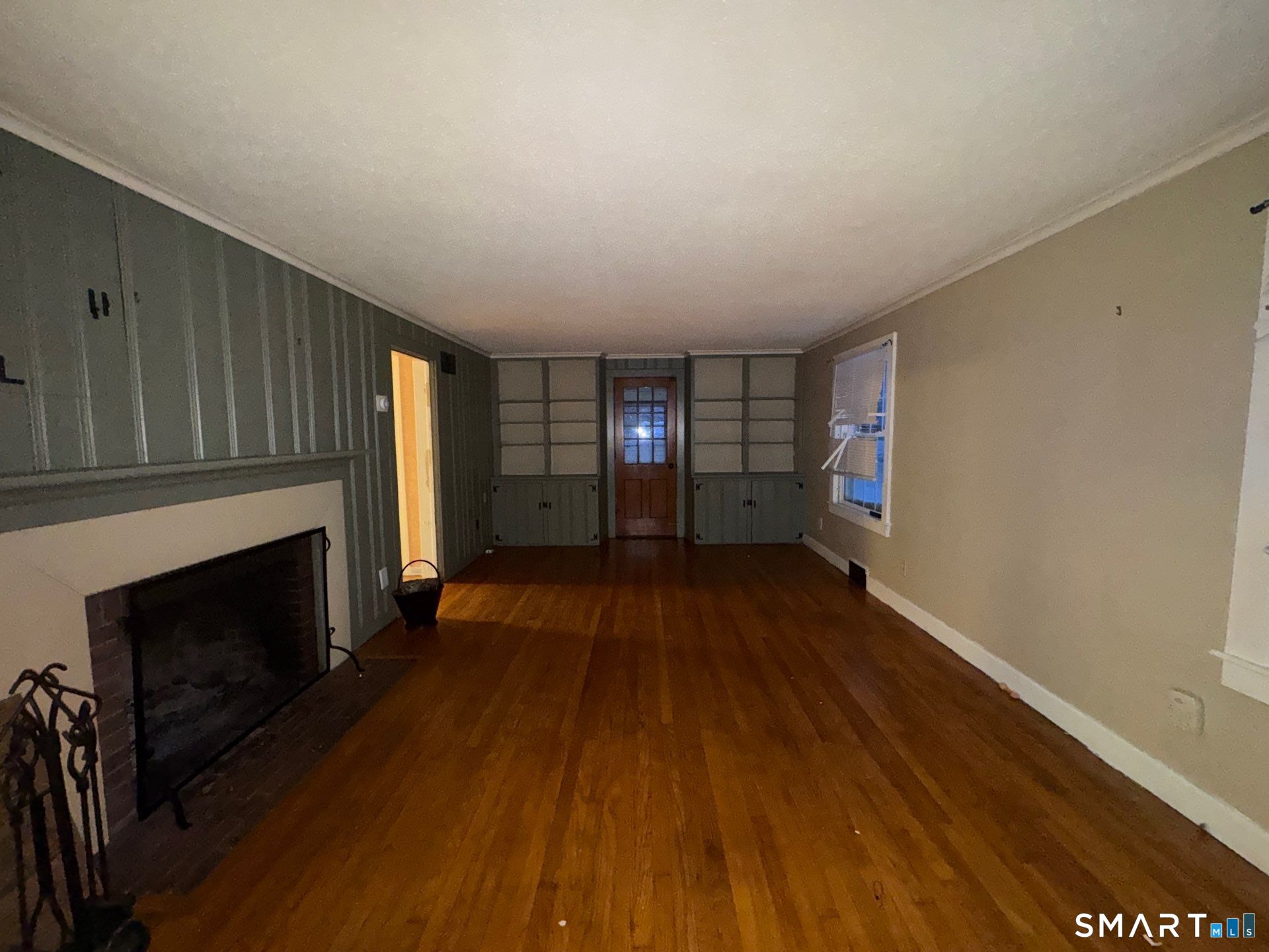 81 Lancaster Road Bristol, CT 06010 - Photo 9 of 30 a view of empty room with wooden floor and fireplace