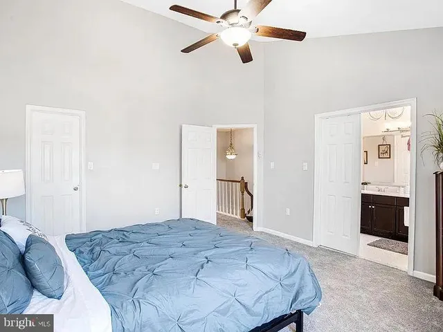 a view of a dining room with wooden floor a chandelier a wooden table and chairs