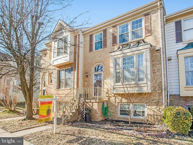 10864 Caraway Circle Manassas, VA 20109 - Photo 14 of 16 a view of a brick building next to a yard