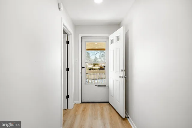a view of a hallway with wooden floor