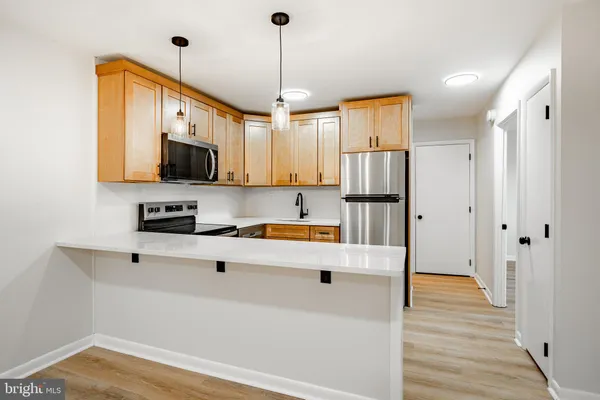 a kitchen with stainless steel appliances a refrigerator sink and microwave
