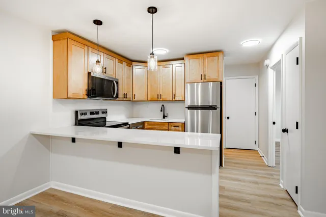 a kitchen with stainless steel appliances a refrigerator sink and microwave