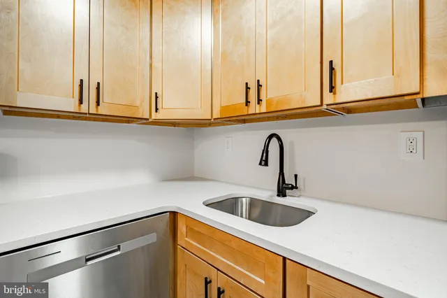 a kitchen with a sink and cabinets