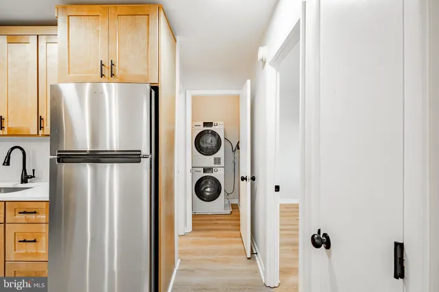 a view of a kitchen with a refrigerator and cabinets