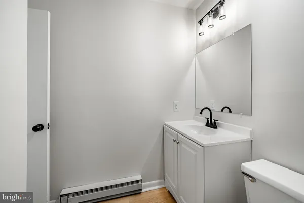 a bathroom with a sink a toilet and a mirror