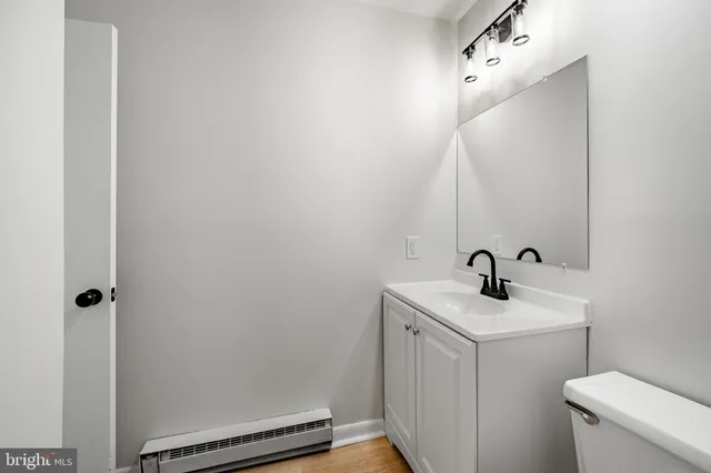 a bathroom with a sink a toilet and a mirror