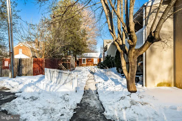 a view of a yard with snow on the road