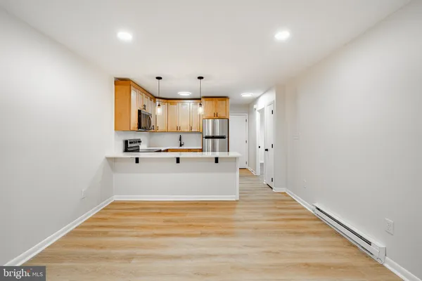 a view of kitchen with microwave and cabinets