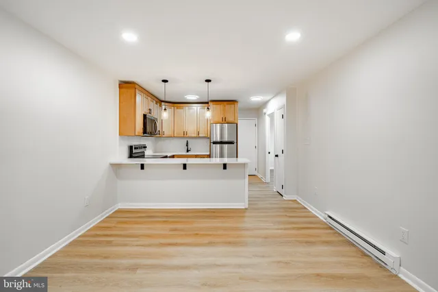 a view of kitchen with microwave and cabinets
