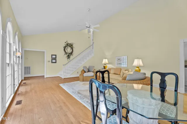 a dining room with furniture and wooden floor