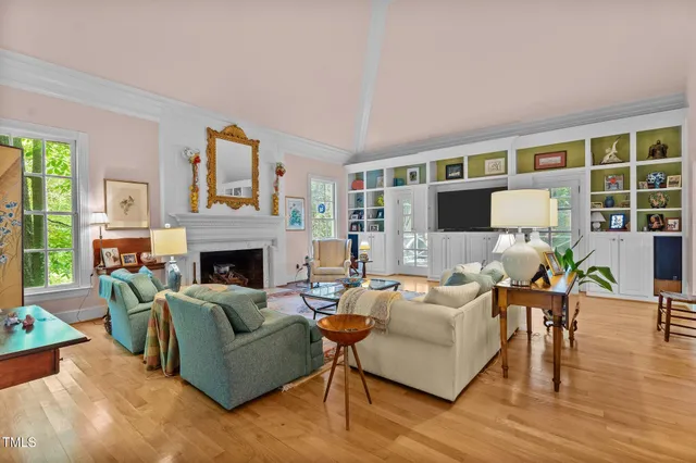 a living room with furniture a fireplace and a flat screen tv