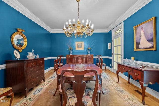 a view of a dining room with furniture and chandelier