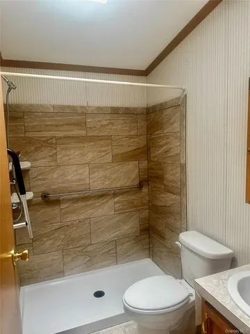 a bathroom with a toilet and a shower