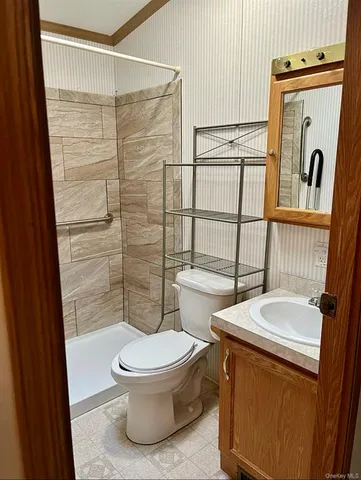 a bathroom with a toilet and a shower