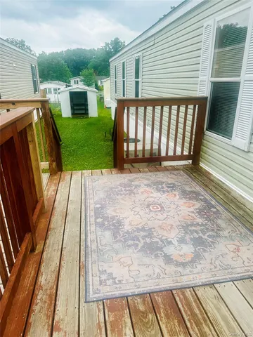 a view of backyard with a deck and hardwood floor