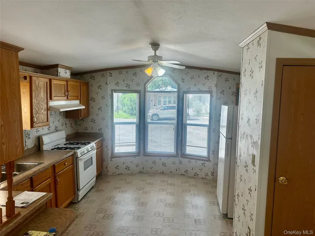 a kitchen with stainless steel appliances granite countertop a stove and a refrigerator
