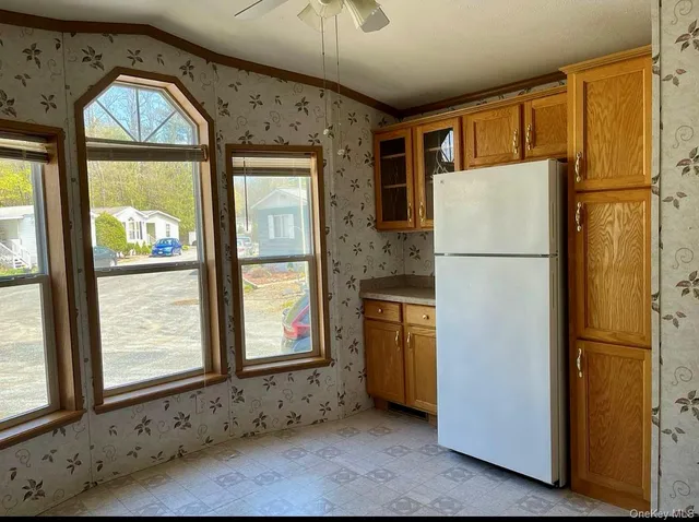 a white refrigerator freezer and a stove sitting inside of a kitchen