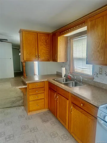 a kitchen with granite countertop a sink and a window