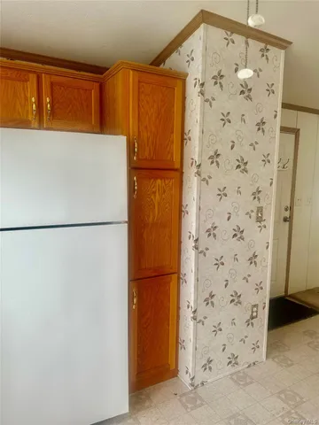a refrigerator freezer sitting in a kitchen