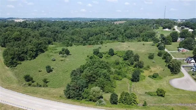 an aerial view of a houses with a yard