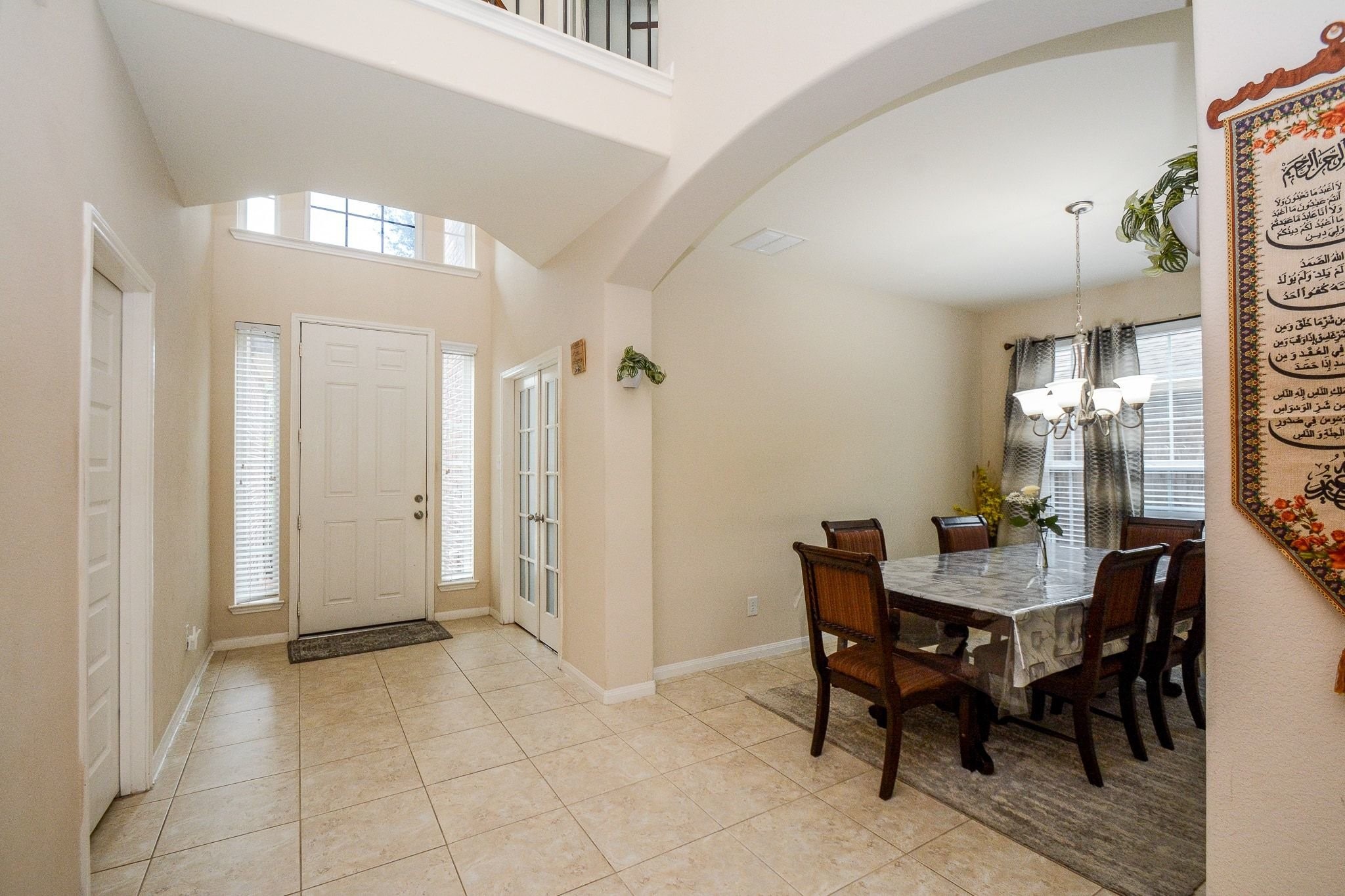 7046 Sliding Rock Circle Spring, TX 77379 - Photo 5 of 41 This inviting dining room features elegant tile flooring, abundant natural light, and a charming chandelier, perfect for memorable gatherings.