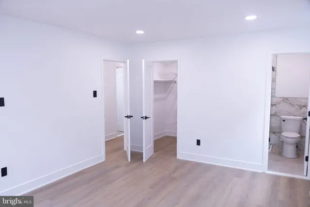 a view of a room with wooden floor and window
