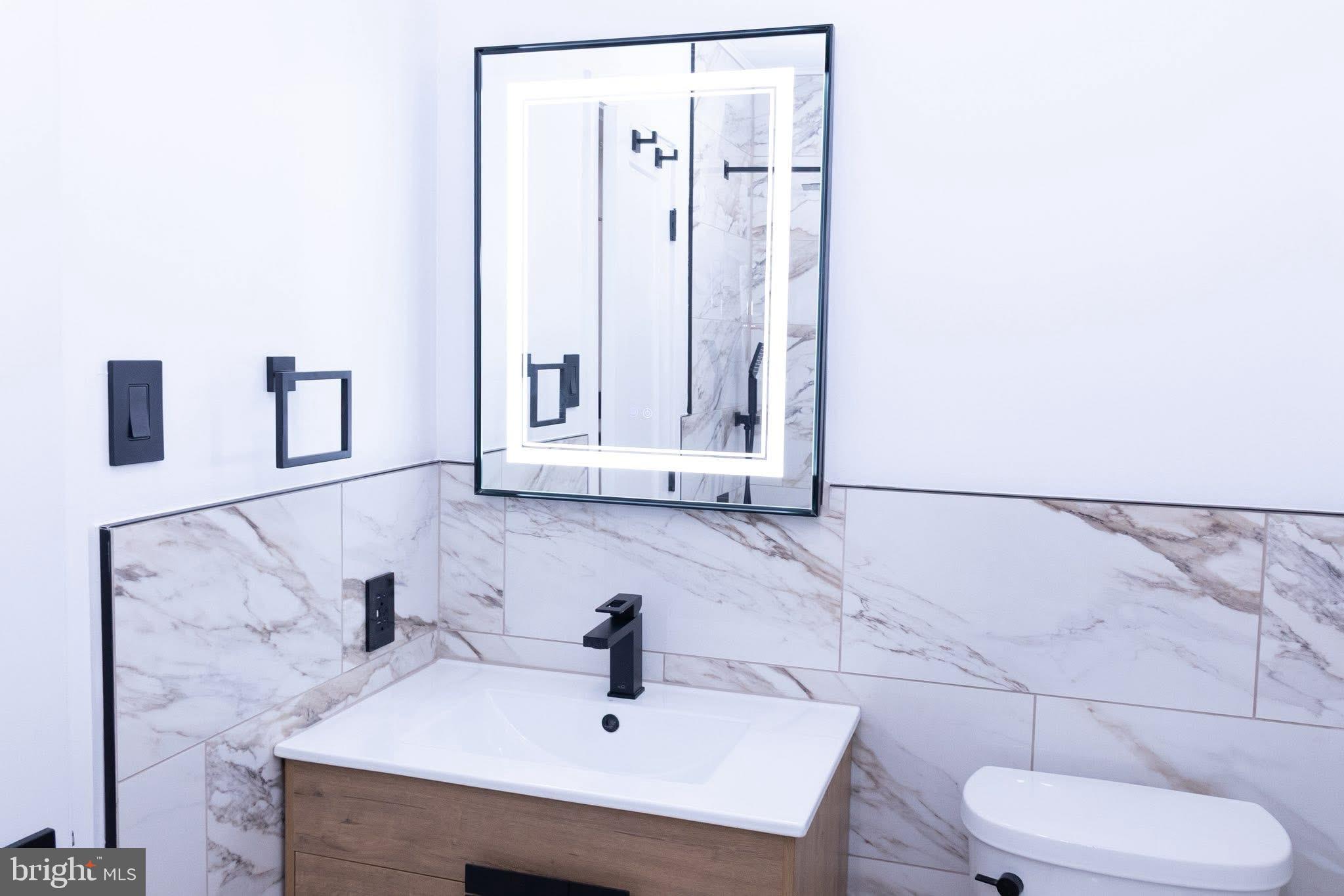 1969 Ambassador Street Philadelphia, PA 19115 - Photo 6 of 11 a bathroom with a sink and a mirror