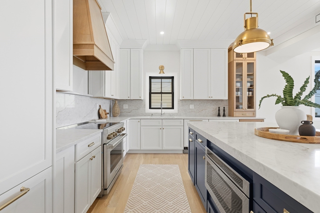 847 East 5th Street, Unit 2 Boston, MA 02127 - Photo 7 of 24 a kitchen with a sink stove and cabinets