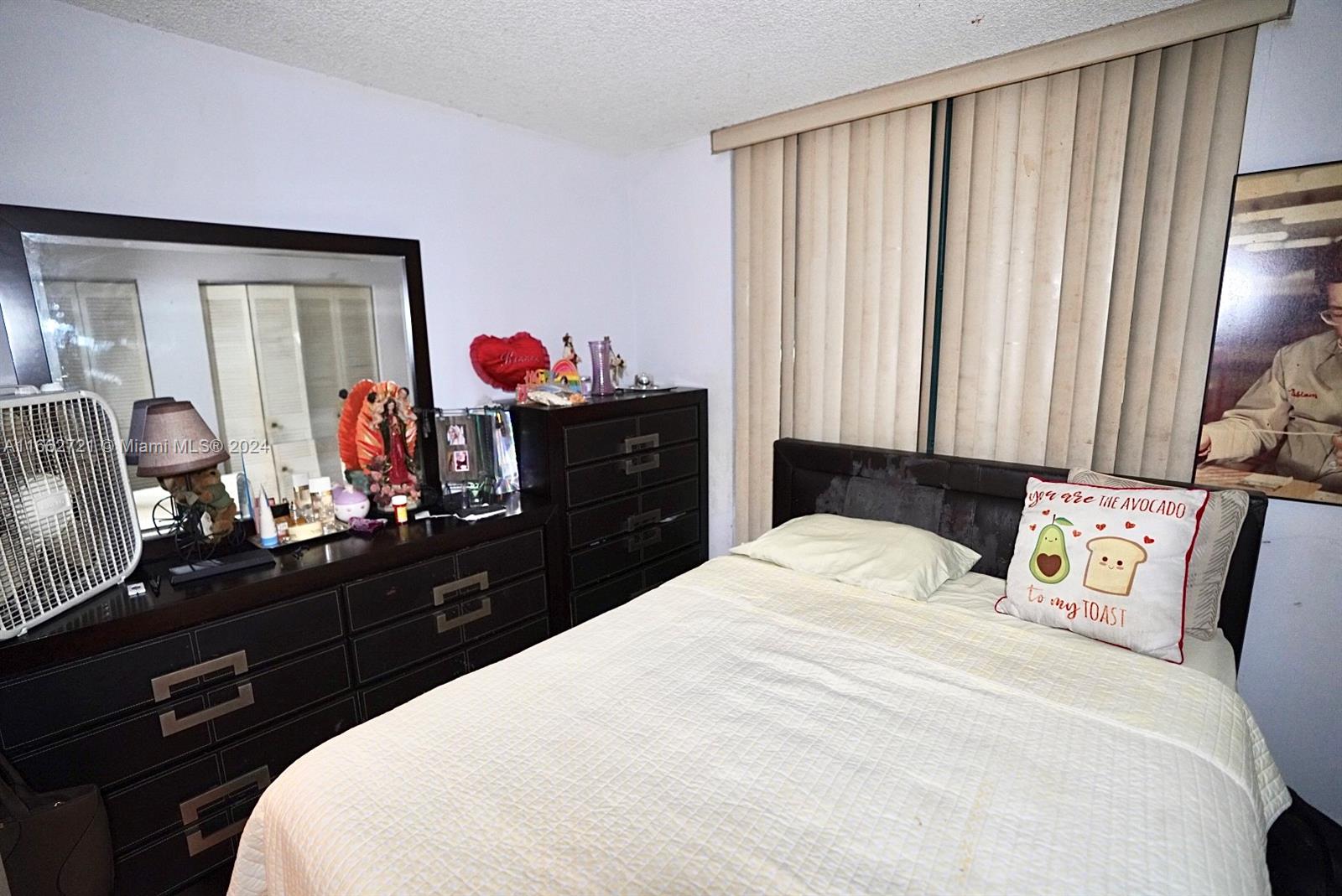 11790 Southwest 18th Street, Unit 2273 Miami, FL 33175 - Photo 15 of 18 a bedroom with a bed and a dresser