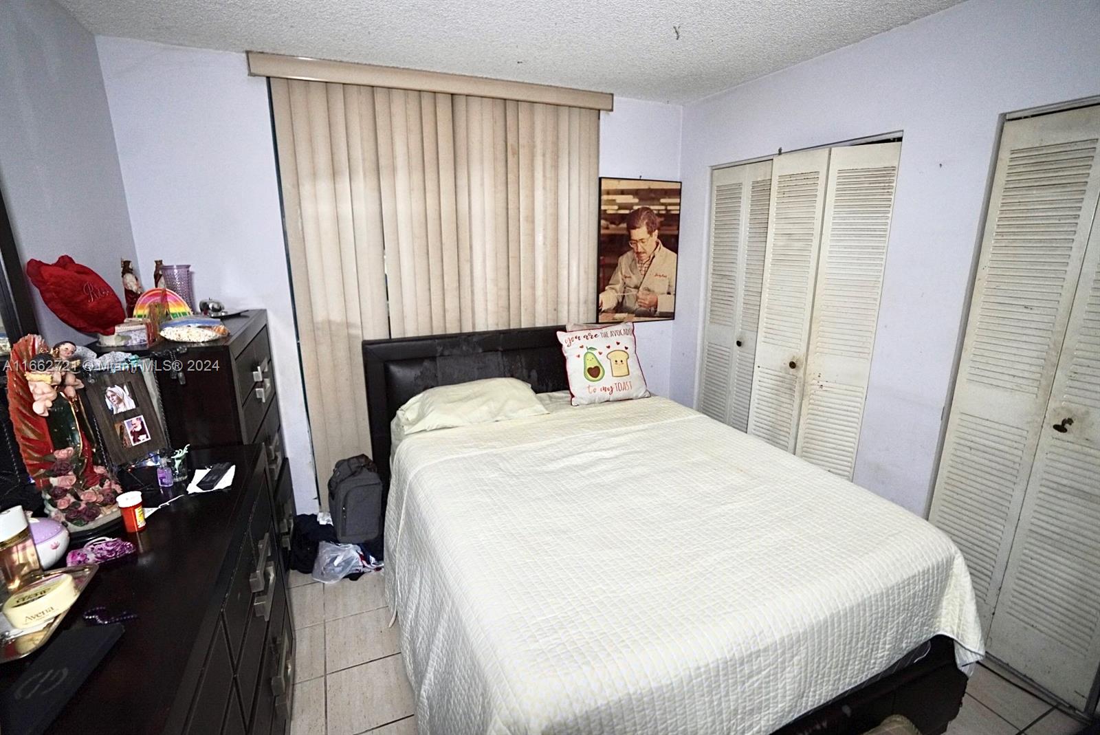 11790 Southwest 18th Street, Unit 2273 Miami, FL 33175 - Photo 16 of 18 a bedroom with a bed and a dresser