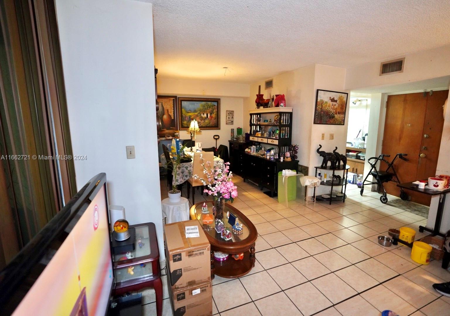 11790 Southwest 18th Street, Unit 2273 Miami, FL 33175 - Photo 7 of 18 a living room with lots of furniture and baby crib