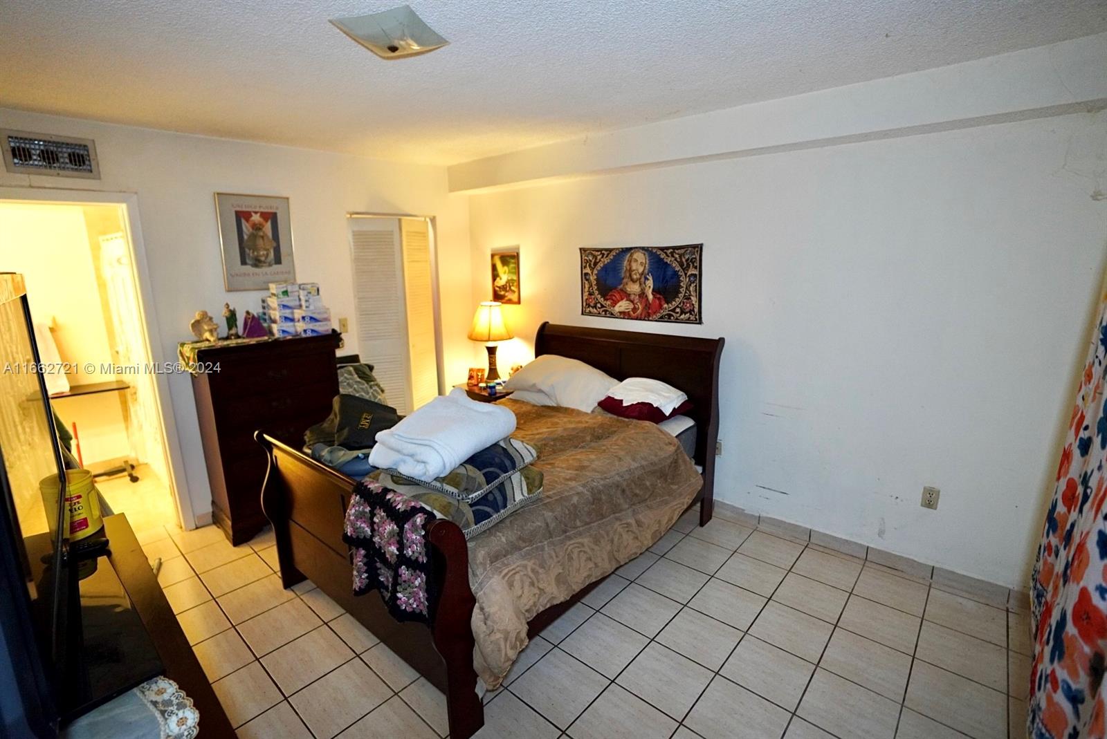 11790 Southwest 18th Street, Unit 2273 Miami, FL 33175 - Photo 10 of 18 a bed room with a bed and a table