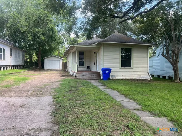a front view of house with yard and outdoor seating