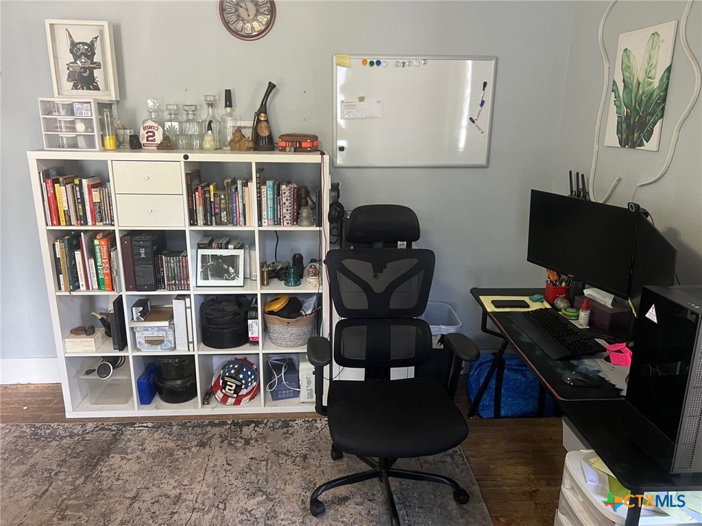 408 Hubbard Street Yoakum, TX 77995 - Photo 11 of 23 a work room with furniture and a book shelf