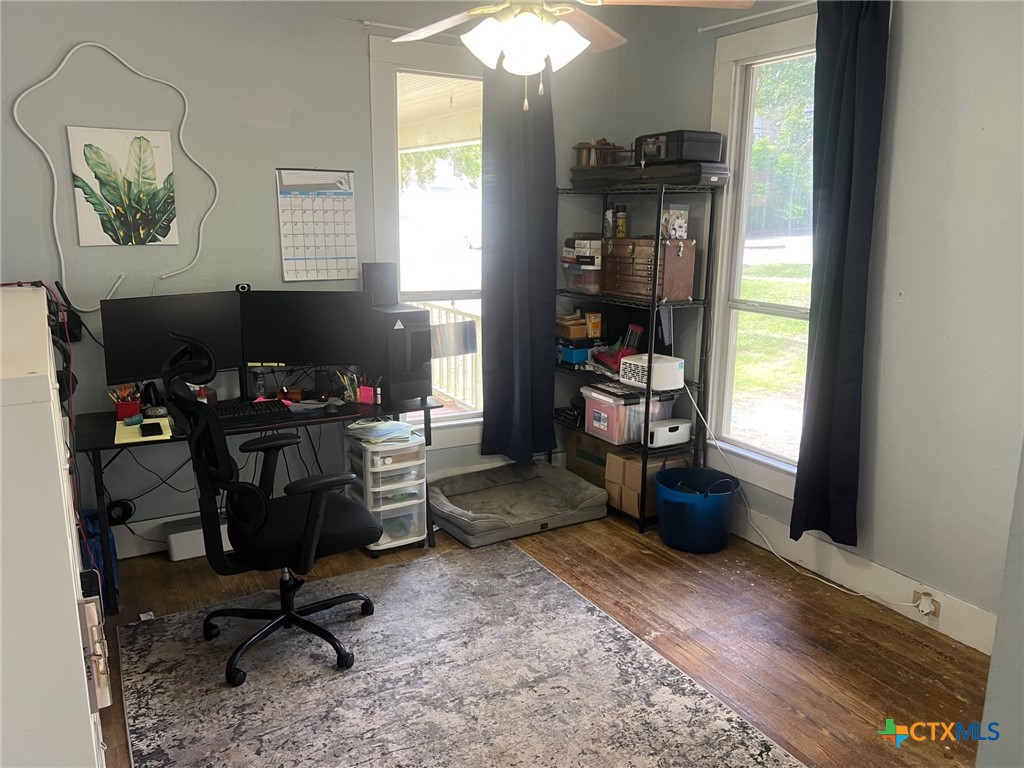 408 Hubbard Street Yoakum, TX 77995 - Photo 13 of 23 a view of a workspace with furniture and a window