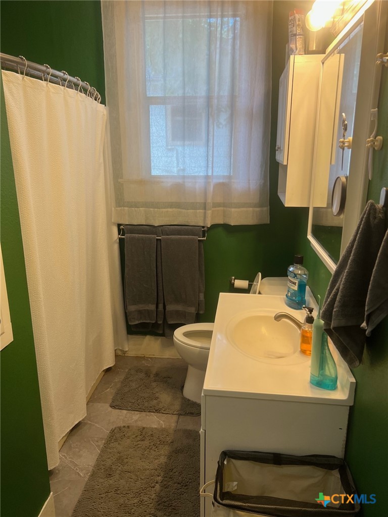 408 Hubbard Street Yoakum, TX 77995 - Photo 14 of 23 a bathroom with a sink and a mirror