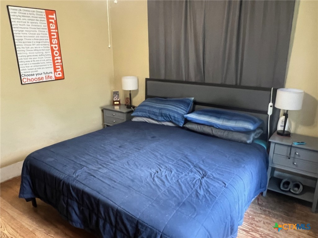 408 Hubbard Street Yoakum, TX 77995 - Photo 15 of 23 a bed sitting in a bedroom next to a window