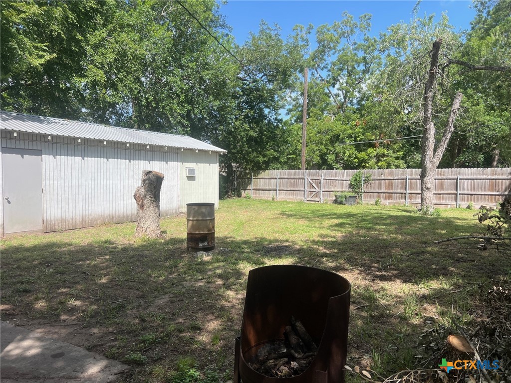 408 Hubbard Street Yoakum, TX 77995 - Photo 20 of 23 a view of a backyard with large trees