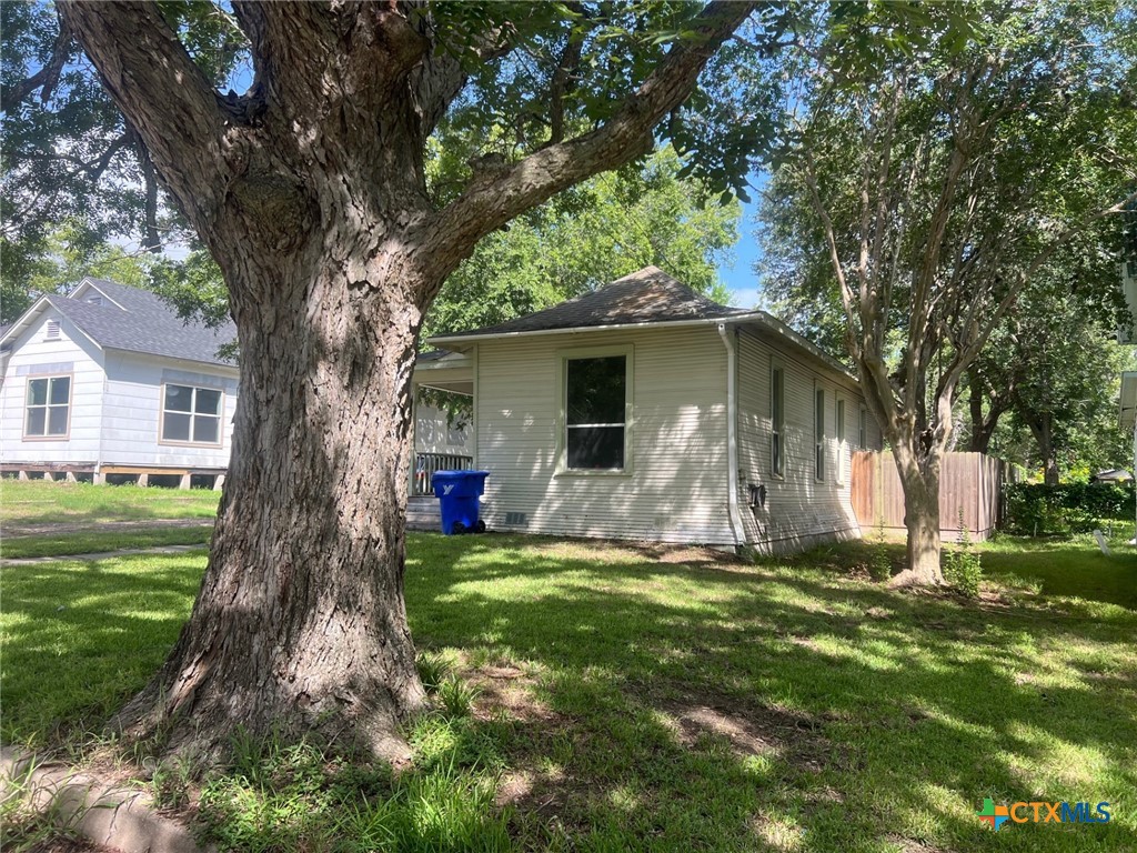408 Hubbard Street Yoakum, TX 77995 - Photo 3 of 23 a view of a house with a yard