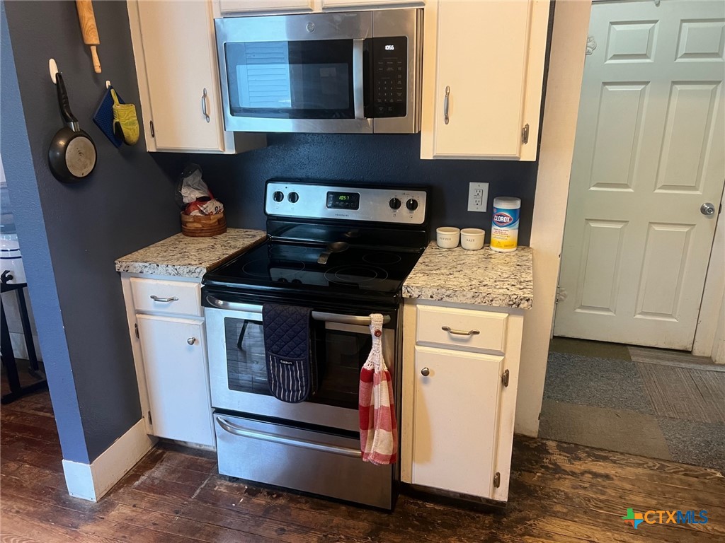 408 Hubbard Street Yoakum, TX 77995 - Photo 10 of 23 a kitchen with stainless steel appliances granite countertop a stove and a refrigerator