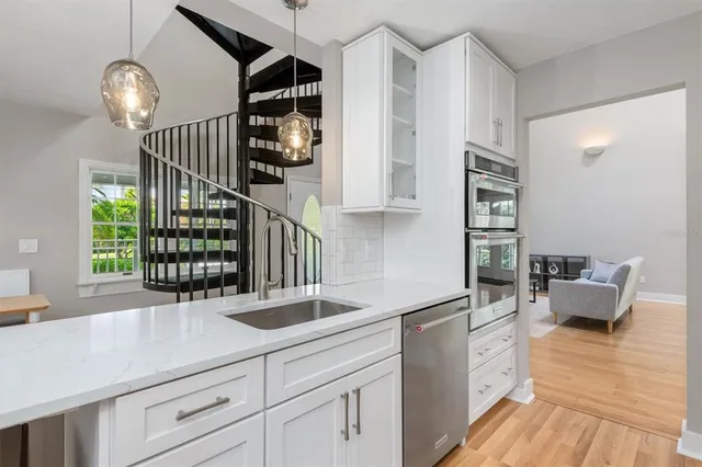 a kitchen with appliances cabinets and a counter top space