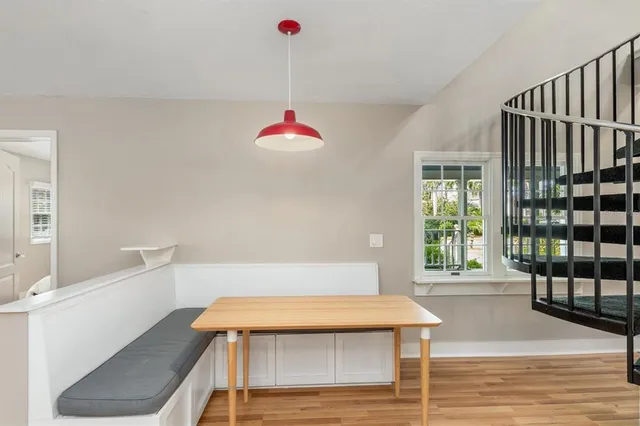 a room with pool table and windows