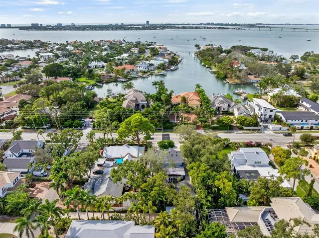 an aerial view of lake and residential houses with outdoor space