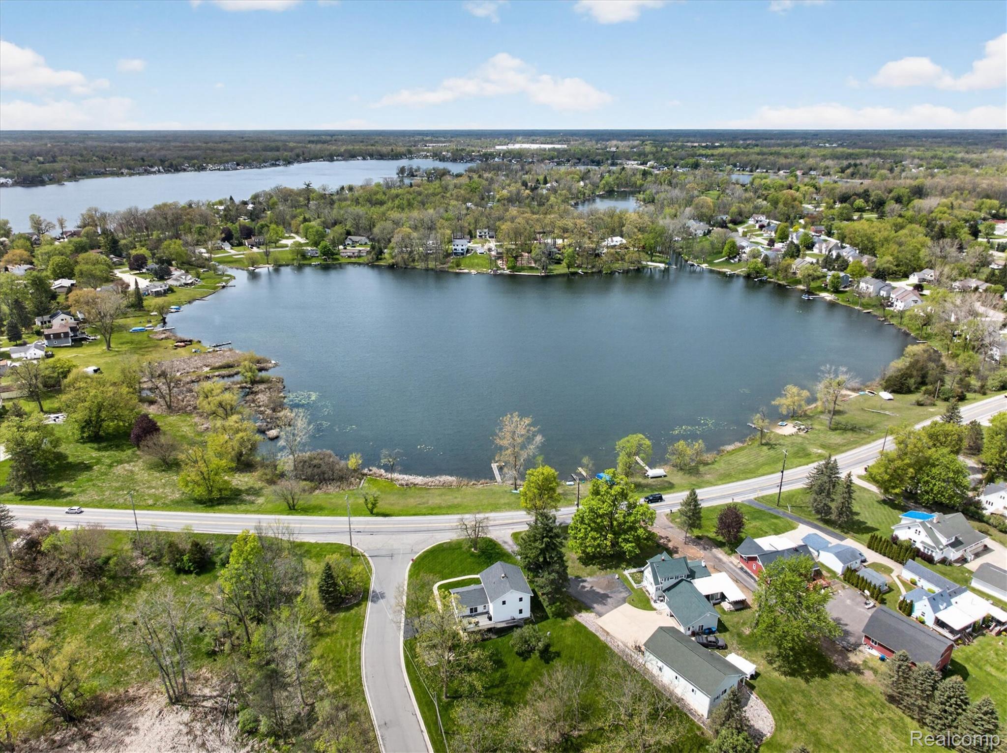 12409 Fenton Road Fenton, MI 48430 - Photo 48 of 61 Aerial perspective of suburban area featuring a nearby body of water