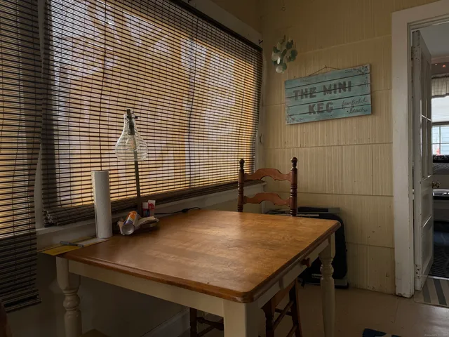 a room with pool table and windows