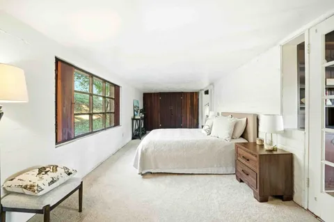 a bedroom with a bed and a window