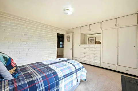 a bedroom with a bed and walk in closet