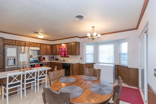 a bedroom with a bed wooden floor and window