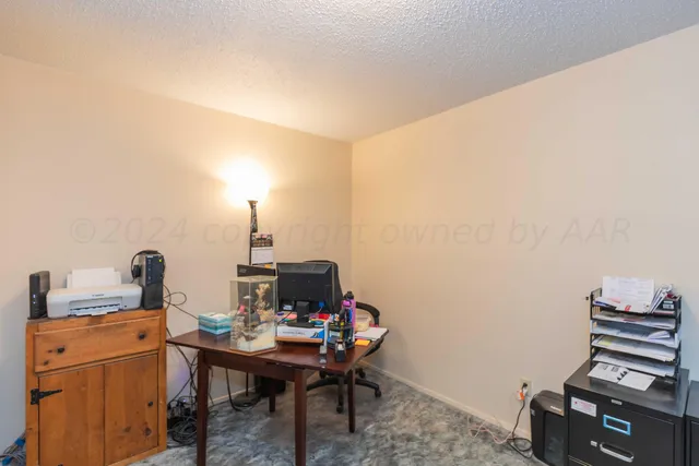 a living room with a fireplace furniture and a large window
