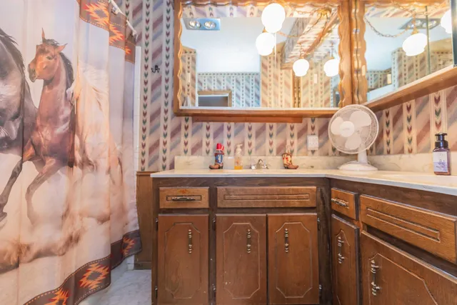 a bedroom that has a bed and a flat screen tv